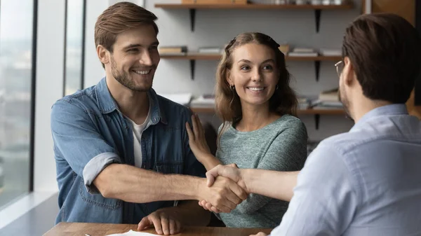 Glückliches Paar gibt beim Treffen Handschlag-Referentin ab — Stockfoto