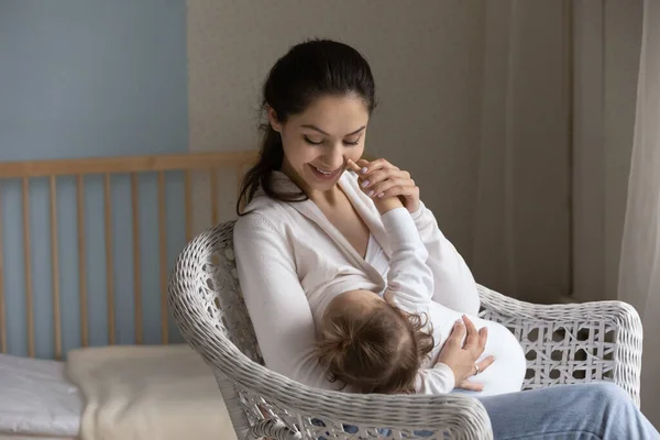 Happy young mom enjoying breastfeeding baby, motherhood, emotional bonding — Stock Photo, Image