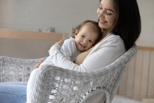 Leende ung mamma kramar och kramar lilla dotter — Stockfoto