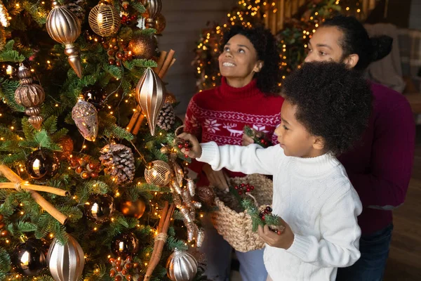 Happy biracial family decorate Christmas tree together — Stock Photo, Image