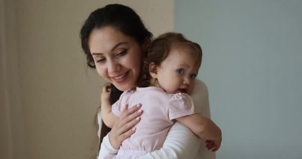 Loving mother cuddling her adorable baby girl — Stock Video