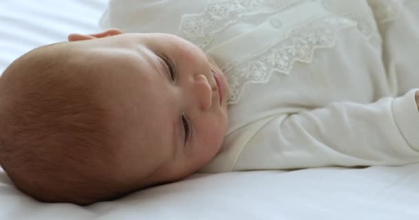 Beautiful peaceful newborn baby lying on bed, close up — Stock Video