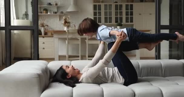 Joyful young asian mother playing with cute son. — Stock Video