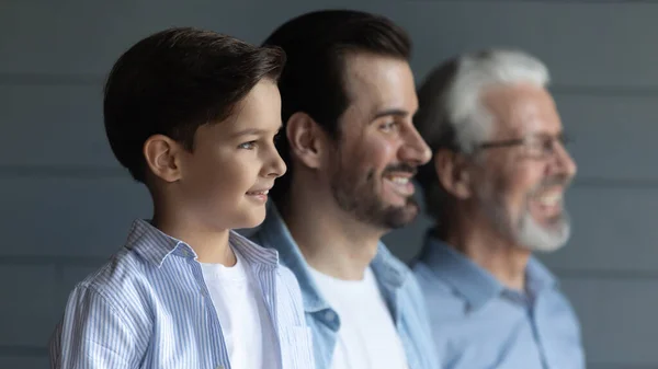 Head shot of three generations of men standing in row — Stock Photo, Image