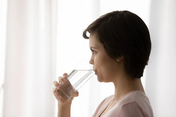 Healthy young female hold glass drink still mineral water — Stock Photo, Image