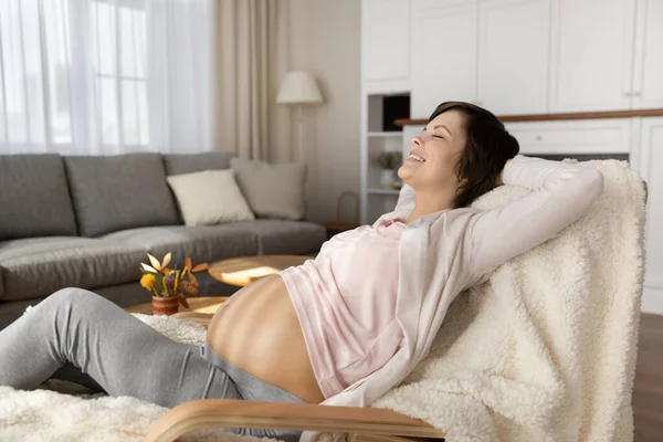 Serene young expectant mom relax at home hands over head — Stock Photo, Image
