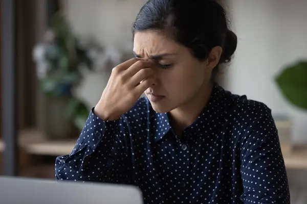 Close up Indian woman touching nose bridge, suffering from headache — Stock Photo, Image