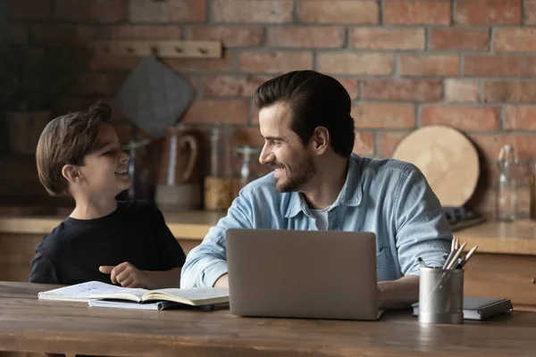 Sonriente padre distraído de la línea de trabajo de chat con su hijo — Foto de Stock