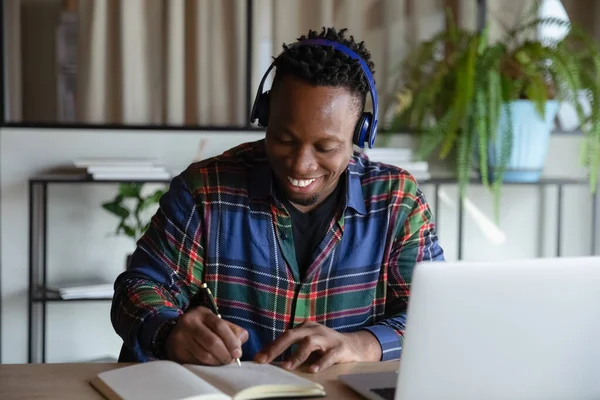 Happy student guy in wireless earphones taking distance learning course — Stock Photo, Image