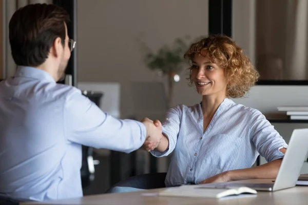 Happy confident young businesswoman shaking hands with client — Stock Photo, Image