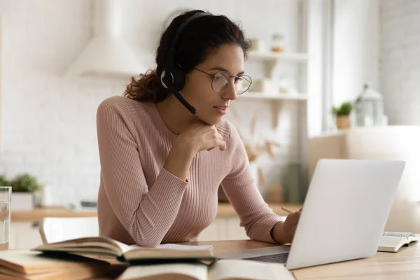 Young Caucasian woman in headphones study online on computer — Stock Photo, Image