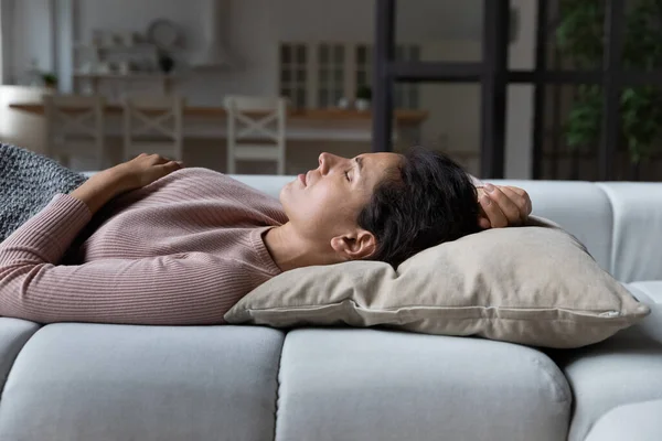 Sakin bir kadın evdeki kanepede huzur içinde uyur. — Stok fotoğraf