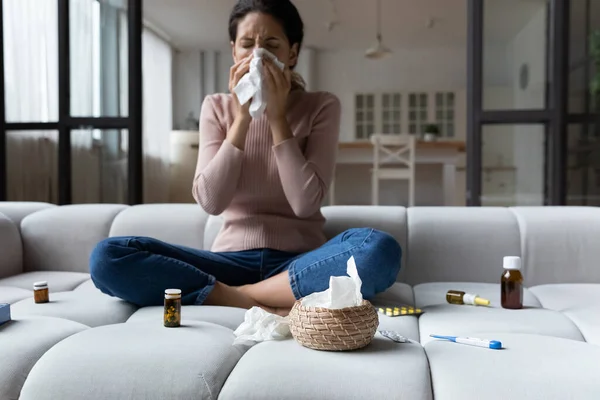 Unhealthy woman sneeze suffering from cold at home