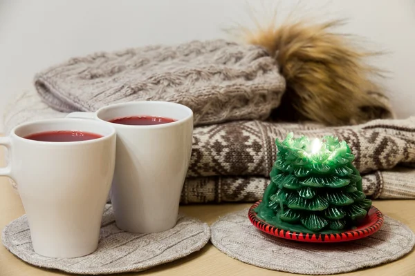 Winter clothes, two cups of mulled wine and candle — Stock Photo, Image