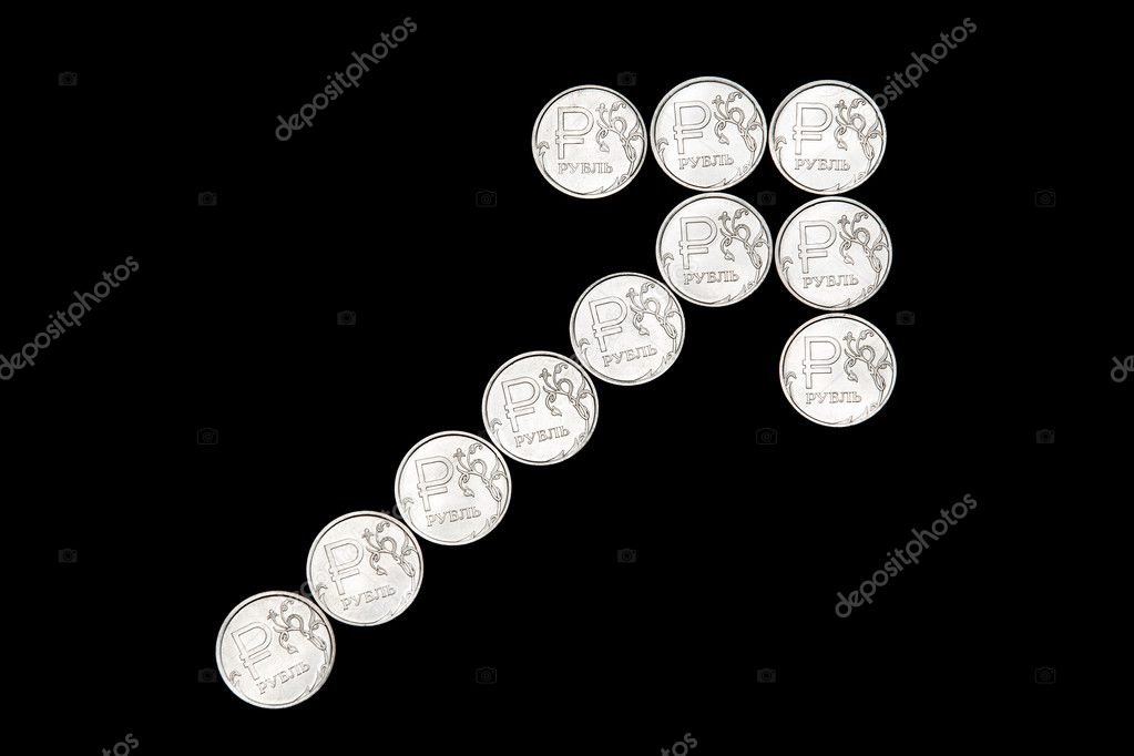 Several metal Russian ruble coins on black background form up arrow