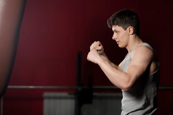 Young man warming up boxing in gym