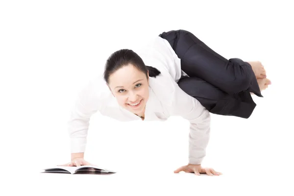 Young woman in formalwear doing fitness exercises with book on w — Stock Photo, Image