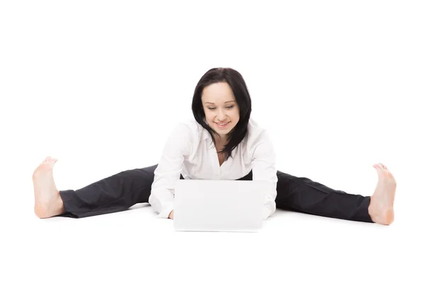 Young office woman sitting in splits with laptop on white backgr — Stock Photo, Image