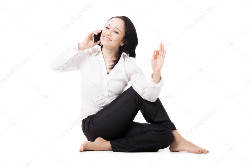 Young business woman in yoga pose making call on white backgroun