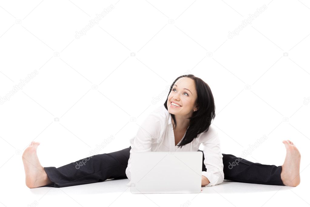 Young office woman with laptop doing splits on white background 