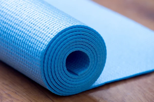 Folded blue yoga mat — Stock Photo, Image
