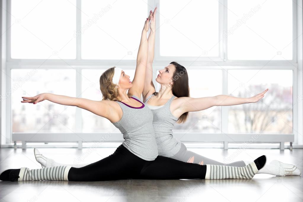 Sporty young dancers doing splits