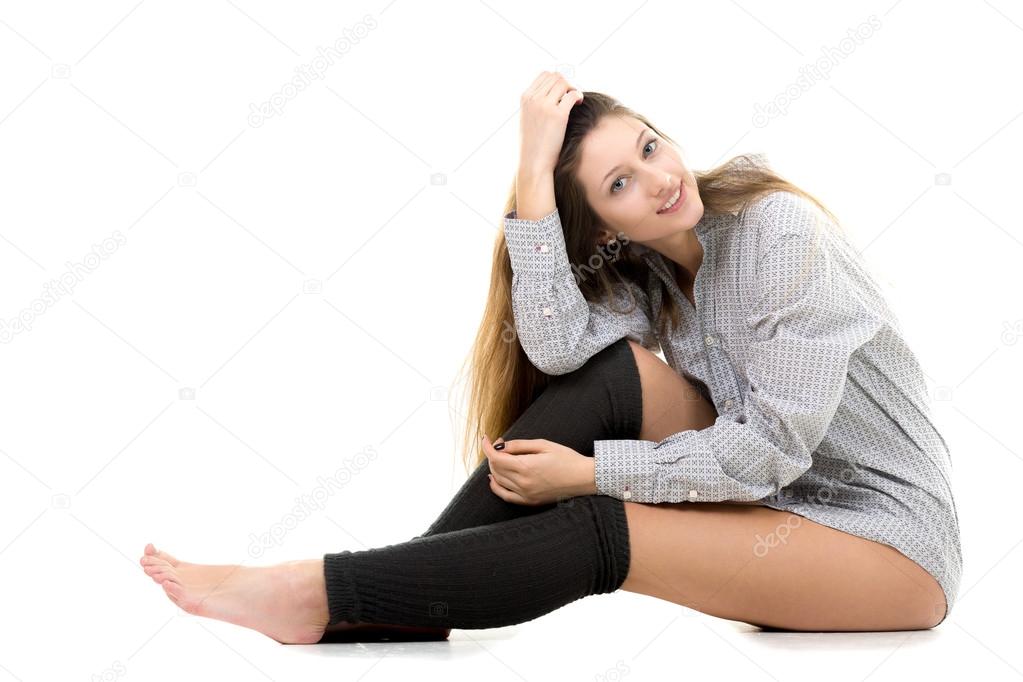 Smiling attractive young girl in shirt and gaiters