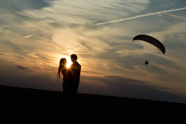 Couple of lovers against rising sun — Stock Photo, Image