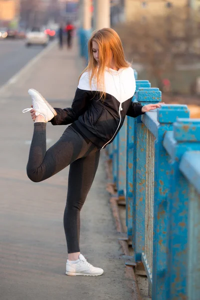 Runner girl stretching before running practice — Stock Photo, Image