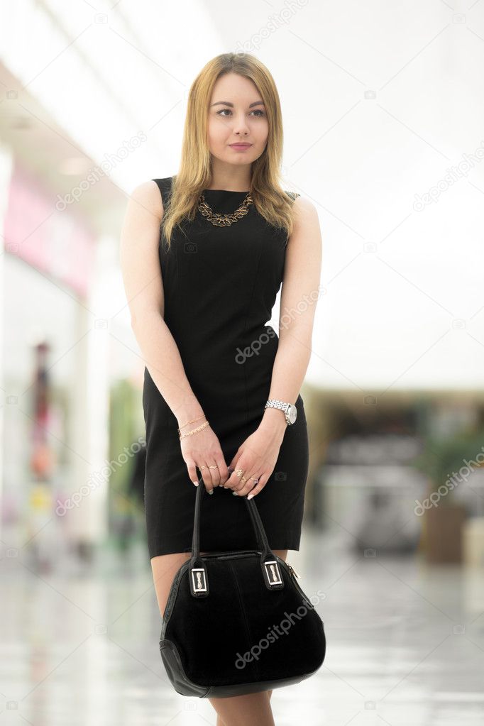 Young woman with suede bag, close up