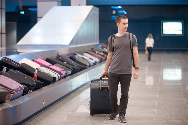 Young man at conveyor belt — Stock Photo, Image