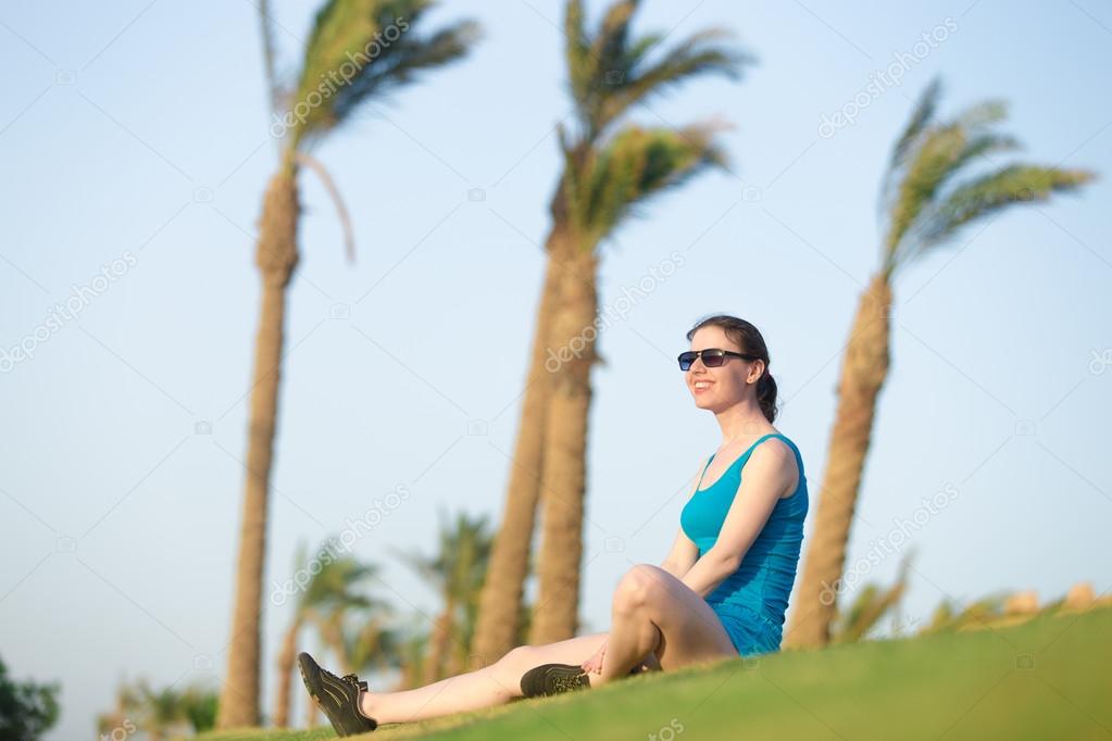 Young woman relaxing in sunlight after fitness workout