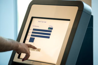 Man doing self-registration for flight, close up