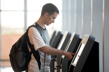 Man doing self-registration for flight clipart