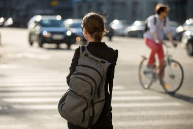 Young woman crossing street