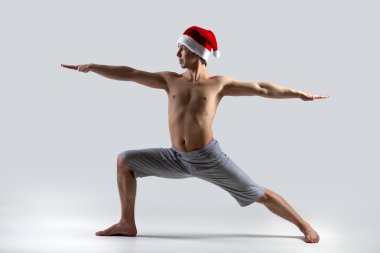 Yoga Pose Warrior 2 in Santa Claus hat clipart