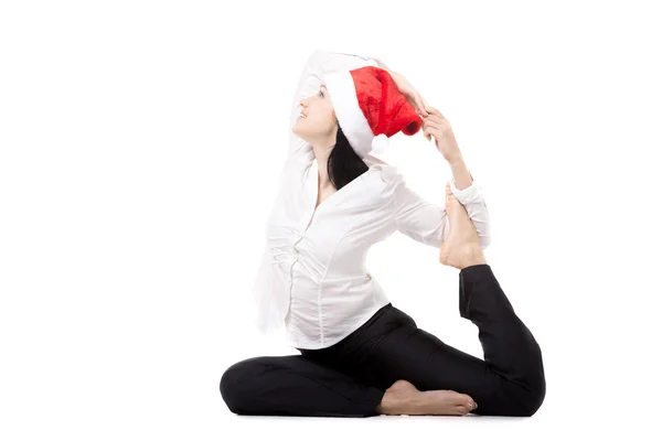 Junge Bürofrau in Big-Zeh-Yoga-Pose im Weihnachtsmann-Hut auf wh — Stockfoto