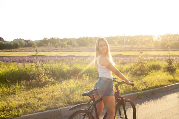 Giovane ragazza adolescente in bicicletta sotto il sole — Foto Stock