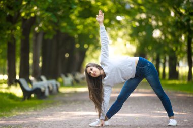 Yogic workout on park alley