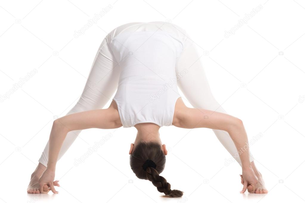 Yogi female standing in Wide Legged Forward Bend