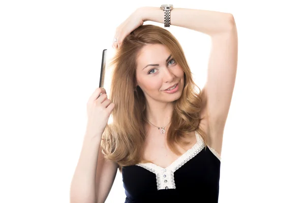 Young woman arranging her hair — Φωτογραφία Αρχείου