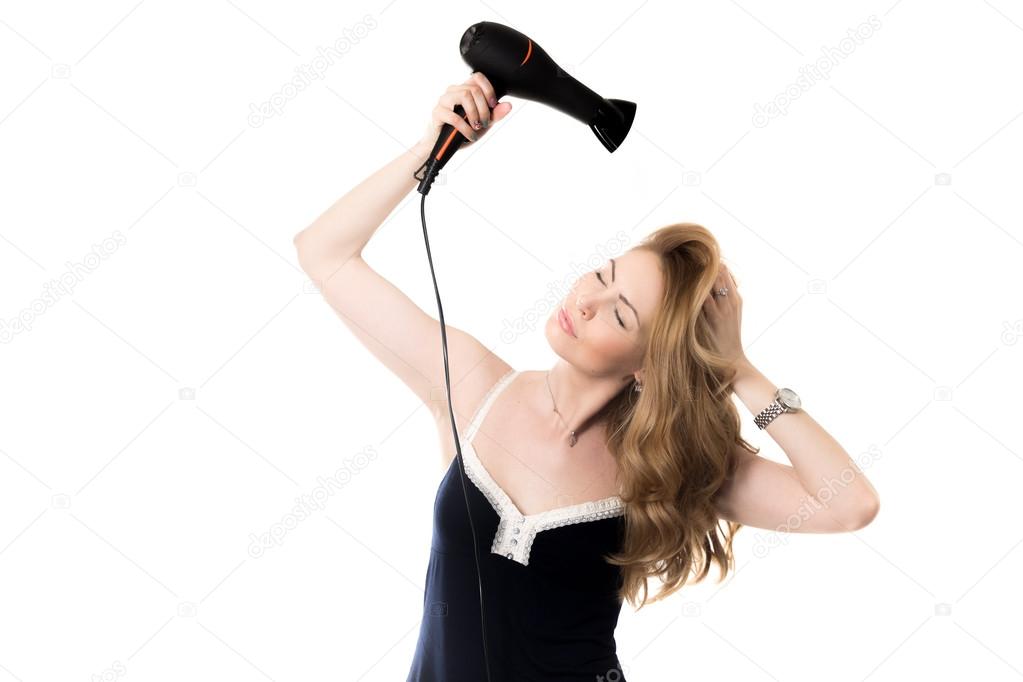 Female model drying her hair with hairdryer 