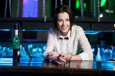 Smiling brunette bartender at nightclub