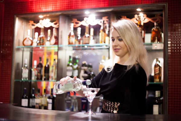 Bartender girl serving martini