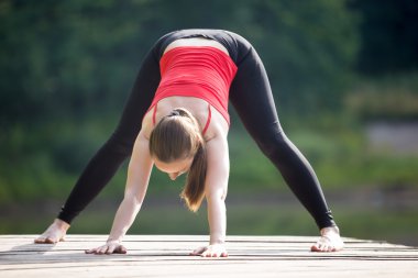 Teenage girl doing Wide Legged Forward Bend