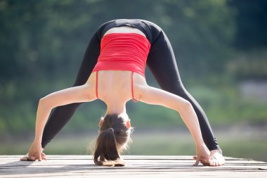 Teenage girl doing Standing Straddle Forward Bend 