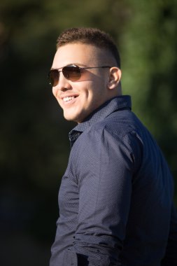 Cheerful young man in sunglasses 