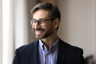Creative mindset. Head shot portrait millennial man in eyewear formal suit business leader look aside with smile create company mission plan marketing move invent business strategy of successful sales