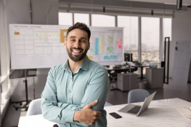 Liderlik ve güven. Portre gülümseyen genç girişimci şirket başkanı modern çevik ofis alanında kendine güvenen bir duruş içinde kariyeriyle gurur duyuyor. Boşluğu kopyala