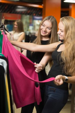 Teenage girls buying clothes